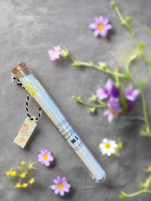 Bath salts in test tube floral background 