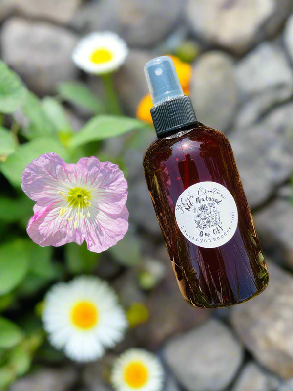bug spray on rock with flowers in background outside