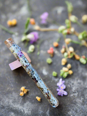 Bath salts in test tube floral background 