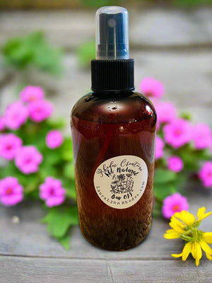 bug spray on wooden table with flowers in background